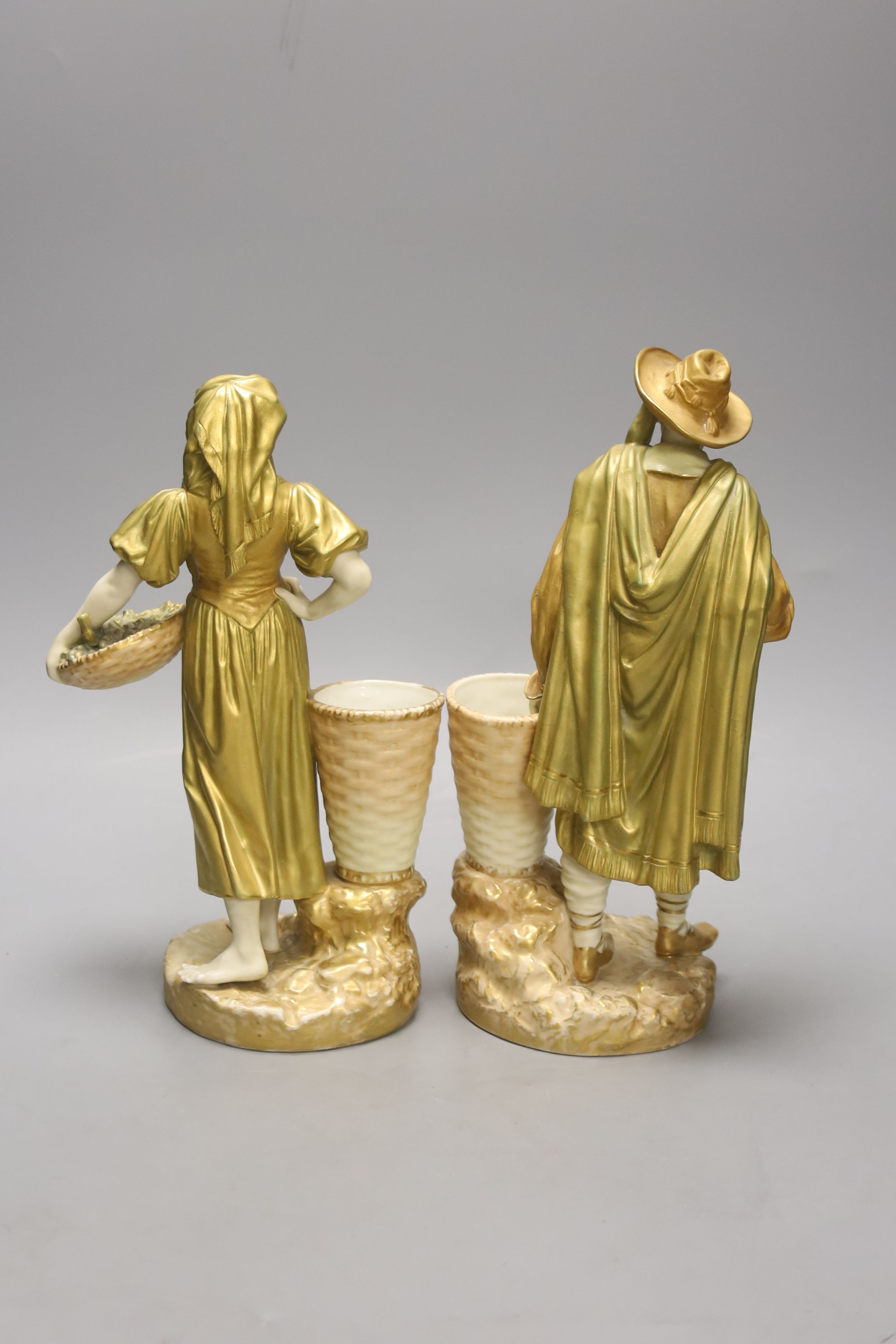 A pair of Royal Worcester blush figures of Spanish grape pickers c.1918, height 25.5cm